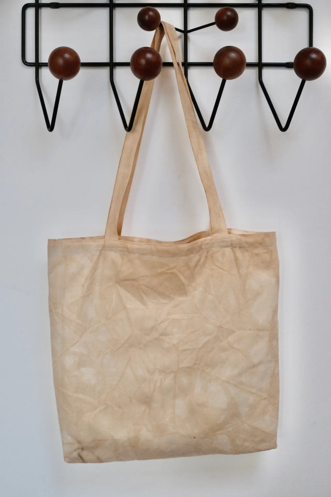 The final tote bag hanging on a wall