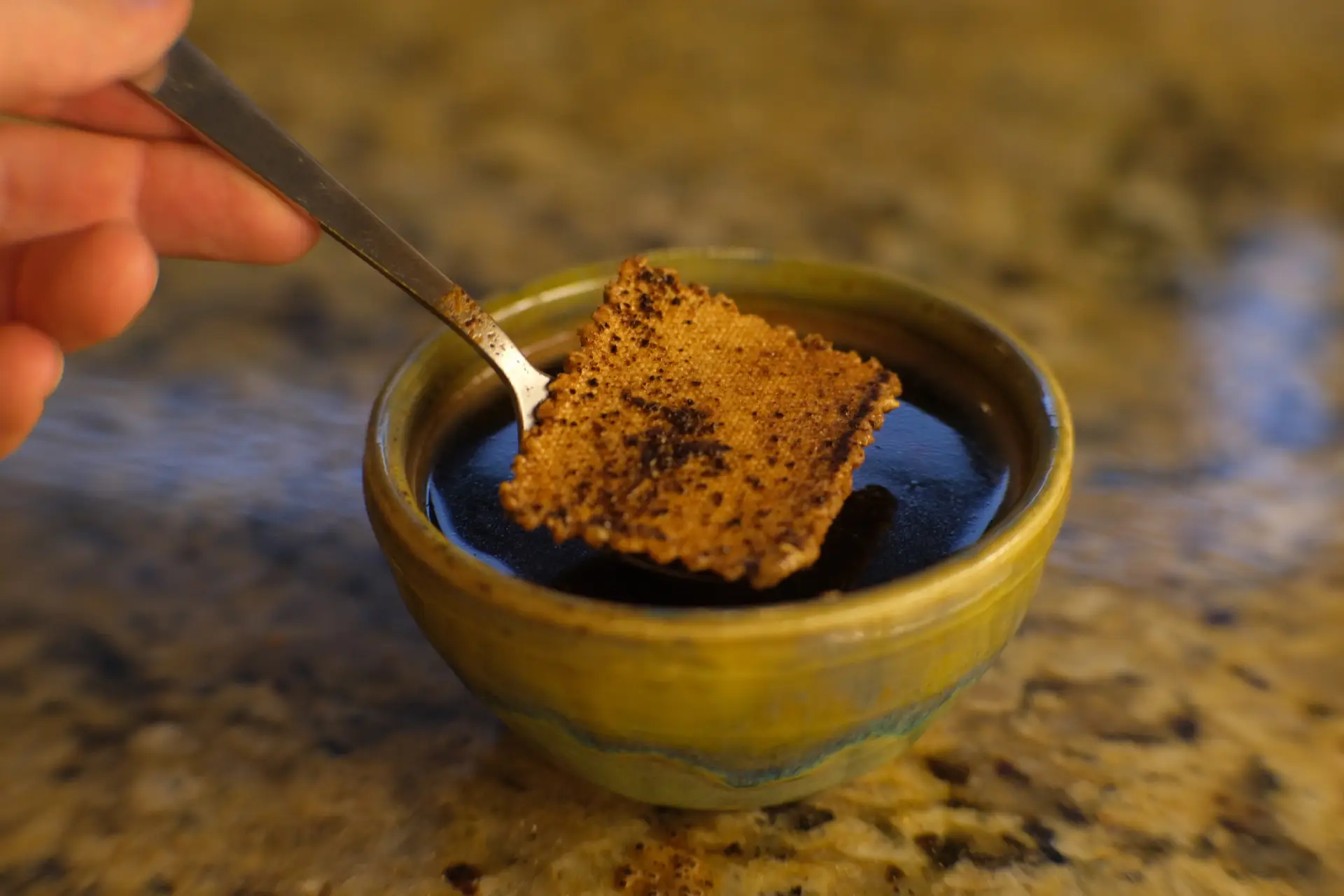 A bowl of coffee with a fabric sample in it